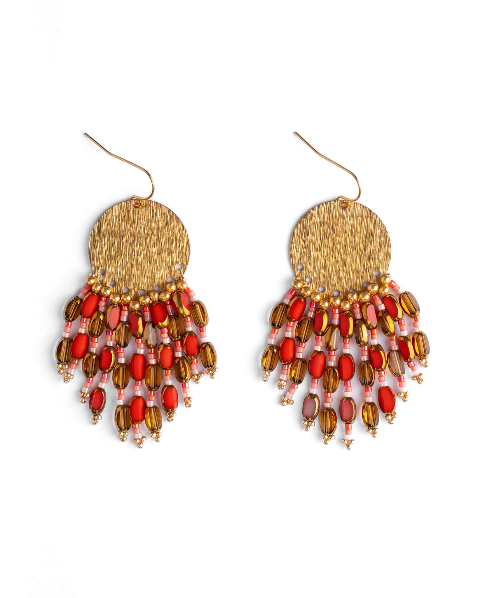 Pair of beaded earrings with gold and red beads on a white background