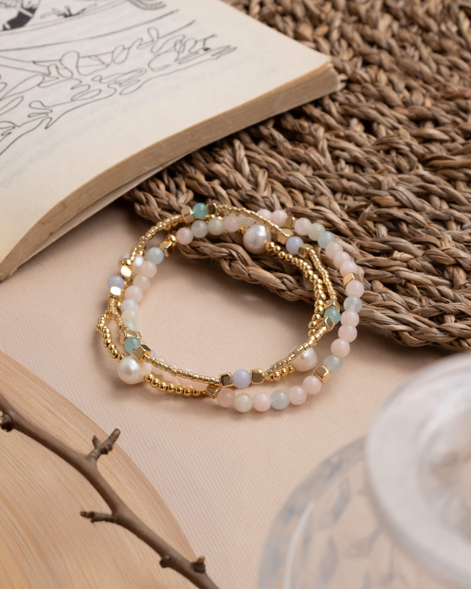Set of beaded bracelets on an open book with a woven mat background